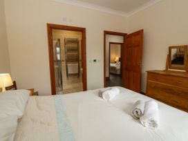 A bedroom with a bed and towels folded on it at Y Bwthyn in Swyddffynnon near Pontrhydfendigaid