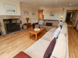 A living room with a sofa and coffee table at Granary Stone House Embleton
