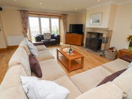 A living room with a sofa and coffee table at Granary Stone House in Embleton
