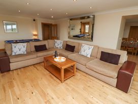 A living room with a sofa and coffee table at Granary Stone House in Embleton