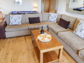 A living room with a sofa and coffee table at Granary Stone House in Embleton