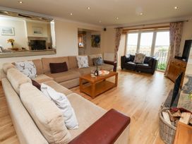 A living room with a sofa and coffee table at Granary Stone House in Embleton