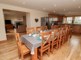 A kitchen with a dining table and chairs at Granary Stone House in Embleton