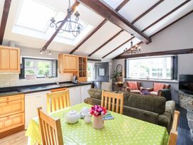 A kitchen with a dining table and chairs at Pear Tree Cottage Mark near Burnham-on-Sea