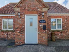A front entrance with a door and windows at Heather Croft in Robin Hood's Bay