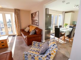 A living room with a sofa and dining area at Heather Croft in Robin Hood's Bay