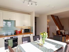 A kitchen with a table and chairs at Heather Croft in Robin Hood's Bay