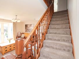 A living room with a staircase and coffee table at Heather Croft in Robin Hood's Bay