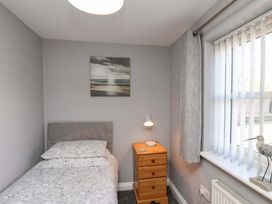 A bedroom with a bed and bedside table at Heather Croft in Robin Hood's Bay