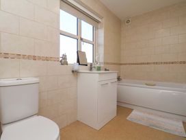A bathroom with a toilet sink and bathtub at Heather Croft in Robin Hood's Bay