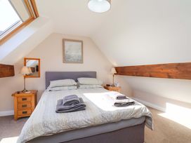 A bedroom with a bed and bedside table at Heather Croft in Robin Hood's Bay