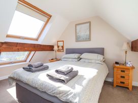 A bedroom with a bed and nightstand at Heather Croft in Robin Hood's Bay