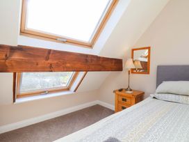 A bedroom with skylights and a wooden beam at Heather Croft in Robin Hood's Bay