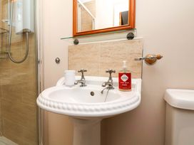 A bathroom with a wash basin and hand wash at Heather Croft in Robin Hood's Bay