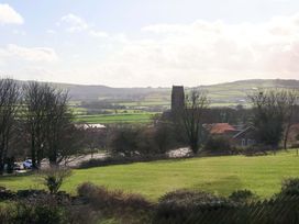 A view of fields and a church at Heather Croft in Robin Hood's Bay