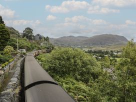 A view of a train traveling through a landscape at Ty Gwynn in Tanygrisiau