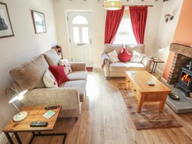 A living room with two sofas and a fireplace at 29 High Street Aldeburgh