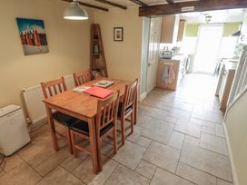 A dining area with a table and chairs at 29 High Street in Aldeburgh