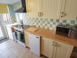 A kitchen with appliances and cabinets at 29 High Street Aldeburgh