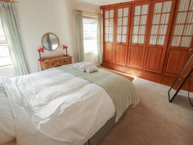 A bedroom with a bed and a wardrobe at 29 High Street Aldeburgh