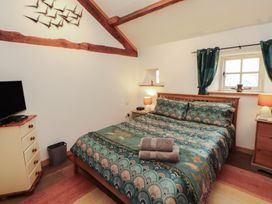 A bedroom with a bed and television at Sonya's Cottage in Anthorn, Solway Firth