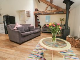 A living room with a sofa and coffee table at The Hayloft near Chester