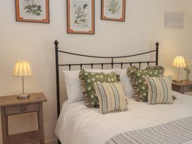 A bedroom with a bed and pillows at The Hayloft in Northop near Chester