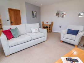 A living room with a sofa and armchair at Pound Cottage Huntshaw near Great Torrington