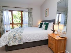 A bedroom with a bed and bedside table at Pound Cottage in Huntshaw near Great Torrington
