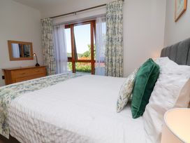 A bedroom with a bed and a dresser at Pound Cottage Huntshaw near Great Torrington