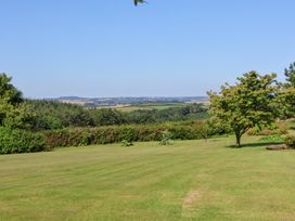 A garden with grass and trees at Pound Cottage in Huntshaw near Great Torrington