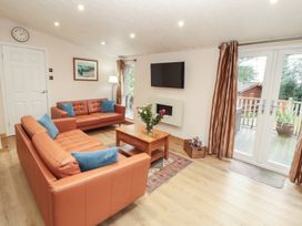 A living room with sofas and a television at Beech Hill Lodge (Beech Hill 9) at Fallbarrow Park, Bowness-on-Windermere
