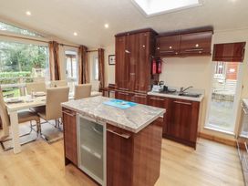 A kitchen with a table and chairs at Beech Hill Lodge (Beech Hill 9) at Fallbarrow Park, Bowness-on-Windermere