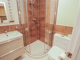 A bathroom featuring a shower, sink, and toilet at Beech Hill Lodge (Beech Hill 9) at Fallbarrow Park