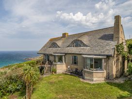 A house with a garden and deck overlooking the sea at Cragford Sennen Cove