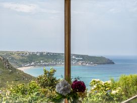 A view of the coastline and sea from a window at Cragford in Sennen Cove