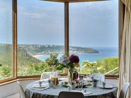 A dining room with a table set for breakfast at Cragford in Sennen Cove