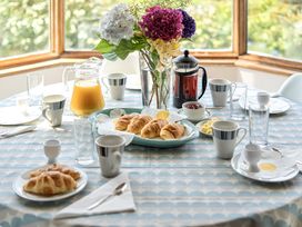 A dining table set with breakfast items at Cragford in Sennen Cove