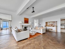 A living room with sofas, a coffee table, and a fireplace at Cragford in Sennen Cove