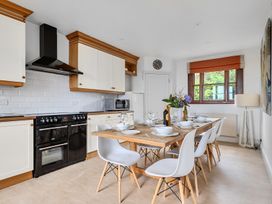 A kitchen with a dining table and chairs at Cragford in Sennen Cove