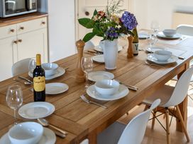 A dining table set with plates and glasses at Cragford Sennen Cove
