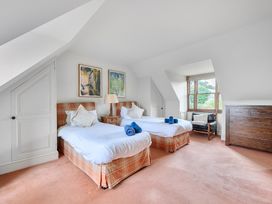 A bedroom with two beds and a dresser at Cragford in Sennen Cove