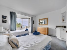 A bedroom with two beds and a dresser at Cragford Sennen Cove