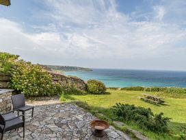 A patio with garden and sea view at Cragford Sennen Cove