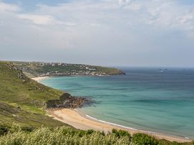 A beach with sand and water at Cragford in Sennen Cove