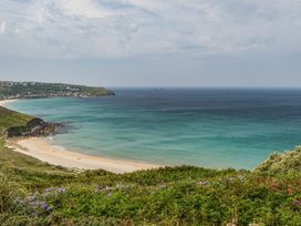 A beach with ocean and hills at Cragford in Sennen Cove