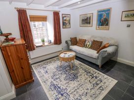 A living room with a sofa and coffee table at Milk Wood Cottage in Laugharne