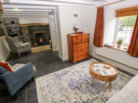 A living room with furniture and a fireplace at Milk Wood Cottage in Laugharne