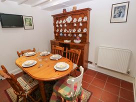 A dining room with a table and chairs at Milk Wood Cottage Laugharne