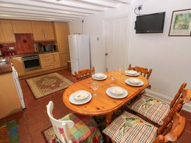 A dining area with a table and chairs at Milk Wood Cottage in Laugharne